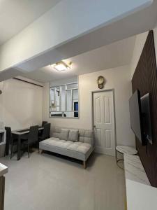 a living room with a couch and a table at The JOYful Stay in Mactan Island