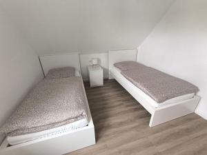 two beds in a small room with at Ferienwohnung-Heide-3 in Walsrode