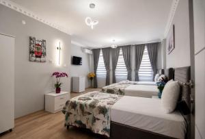 a hotel room with two beds and a tv at Terrace Hotel in Istanbul