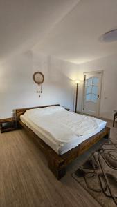 a bedroom with a large bed in a room at Casa de sub Hășmaș in Bălan