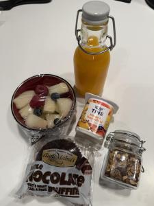 a table with a jar of honey and other food items at Guest rooms, ved Lillestrøm in Lillestrøm