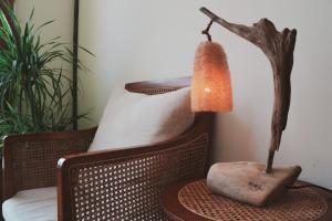 a lamp on a table next to a chair at Sōlis Inn 宿里旅行舍 in Hualien City +88 photos