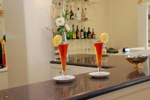 two cocktails sitting on a counter in a kitchen at Hotel La Chiesaccia in Crespellano +3 photos