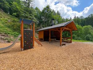 a playground with a slide and a gazebo at Chalupa U Jezu Bělá in Jeseník