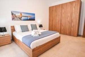 a bedroom with a king sized bed in a room at BH - Three Bedroom Apartments in Sliema