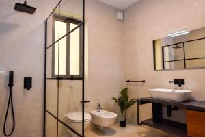 a bathroom with a sink and a toilet and a mirror at BH - Three Bedroom Apartments in Sliema +26 photos