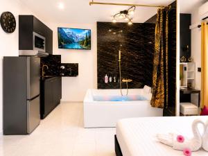 a bathroom with a tub and a large window at Luxury Beach Room in Frontignan