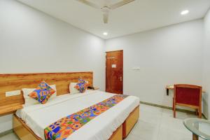 a bedroom with a large bed in a room at FabHotel Vaishnavi Classic in Secunderabad