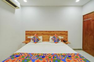 a bedroom with a bed with a colorful bedspread at FabHotel Vaishnavi Classic in Secunderabad