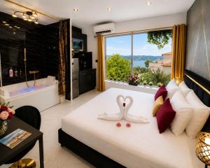 a bedroom with a bed with two swans on it at Luxury Beach Room in Frontignan