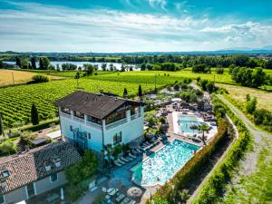 an aerial view of a house with a swimming pool and a vineyard at Bertoletta Village Apartments in Peschiera del Garda