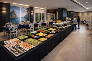 a buffet line with many different types of food at Akman City Hotel in Kuşadası