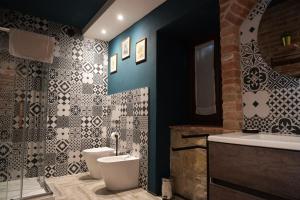 a bathroom with a toilet and a sink at B&B ai SILIO in La Morra