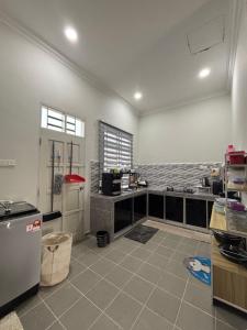 a large kitchen with a counter and a counter top at D Teratak Homestay in Marang