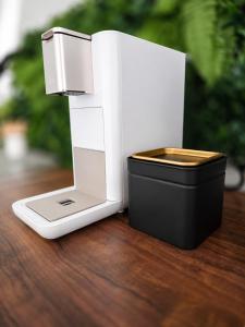 a white and black router sitting on a wooden table at All Homes Apartments Bad Schallerbach in Bad Schallerbach +17 photos