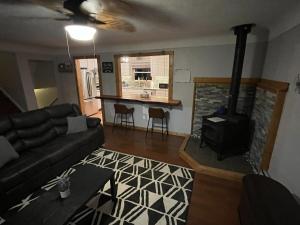a living room with a couch and a fireplace at Trailside Lake Retreat in Gaylord
