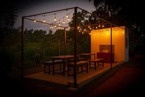 a table and chairs under a tent with lights at Ranketha Hideout Resorts in Kurunegala