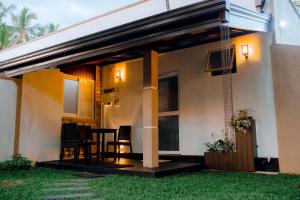 a house with a patio and a table and chairs at Ranketha Hideout Resorts in Kurunegala