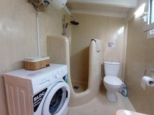 a bathroom with a washing machine and a toilet at Summer House in Corfu Town in Mantoúkion +36 photos
