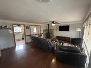a living room with a couch and a table at Trailside Lake Retreat in Gaylord