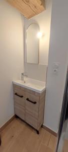 a bathroom with a sink and a mirror at Le Cocon - Vue sur le Port de DINAN - Parking privé in Lanvallay +25 photos