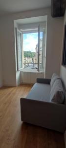 a bedroom with a bed and a large window at Le Cocon - Vue sur le Port de DINAN - Parking privé in Lanvallay