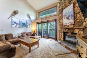 a living room with a couch and a fireplace at Snowdance Manor #405 : 2 in Keystone