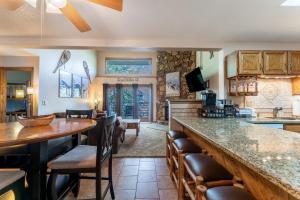 a kitchen with a bar and a living room at Snowdance Manor #405 : 2 in Keystone