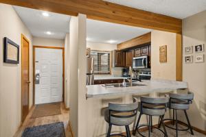 a kitchen with a counter and bar stools at Timber Ridge Retreat in Bellaire