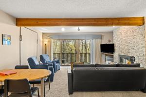 a living room with a couch and a table at Timber Ridge Retreat in Bellaire +26 photos
