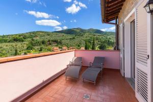 a balcony with chairs and a view of the mountains at La Terrazza di Reggello in Reggello +53 photos