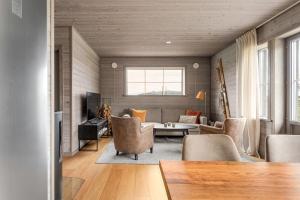 a living room with a couch and a table at Funäsdalshöjden - Funäsdalen in Funäsdalen