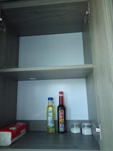 a shelf with two bottles and bowls in a refrigerator at Homestay Vân Canh Hà Nội in Ðại Tự +12 photos
