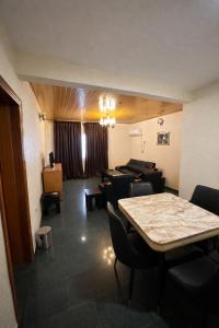 a room with a table and chairs and a couch at Royalbirds Motel in Akure