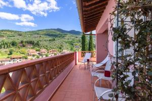a balcony with chairs and a view of the mountains at La Terrazza di Reggello in Reggello