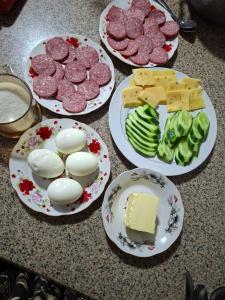 four plates of different types of food on a counter at Ramzan Family Guest House in Samarkand +8 photos