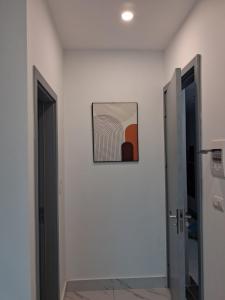 a hallway with two doors and a picture on the wall at Homestay Vân Canh Hà Nội in Ðại Tự