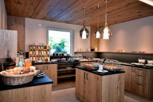 a large kitchen with a counter with food on it at Chalet Anna in Marlengo