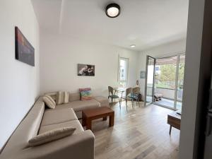 a living room with a couch and a table at Vala Mar Apartments by Four C in Hamallë