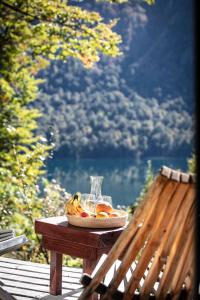 a bowl of fruit on a table on a bench at Hermoso Eco Lodge in San Martín de los Andes