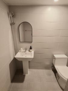 a bathroom with a sink and a toilet and a mirror at Hotel Amy in Pup'yŏng-yŏk +26 photos
