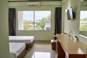 a hotel room with two beds and a window at Yala Rama Hotel in Sathani Yala +28 photos