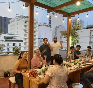 a group of people sitting at tables in a restaurant at Zesty Hostel & Bistro in Nha Trang +20 photos