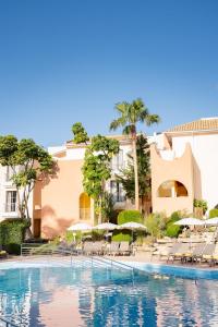 a pool at a hotel with chairs and umbrellas at Four Seasons Vilamoura in Vilamoura