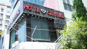 a hotel sign on the side of a building at Hotel Crystal Rajkot in Rajkot