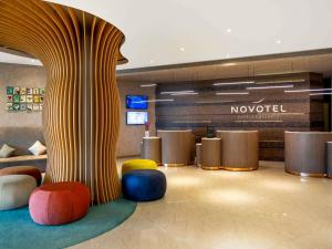 a lobby with colorful chairs and a column at Novotel Istanbul Zeytinburnu in Istanbul