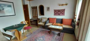 a living room with a couch and a table at Pension Brunner in Bad Kleinkirchheim