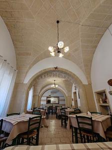 a restaurant with tables and chairs and a ceiling at Masseria Don Egidio in Melendugno +87 photos