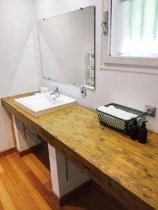 a bathroom with a sink and a mirror at Chez Nanard et Lili in Bec-de-Mortagne