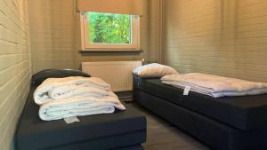 two beds in a room with towels on them at De Zandzegge | 4 persons in Gasselte